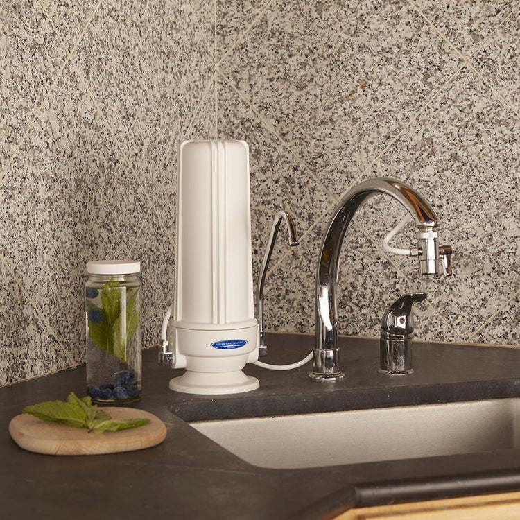 White Polypropylene Fluoride Removal | SMART Single Cartridge Countertop Water Filter System on Kitchen counter next to sink and with faucet attachment